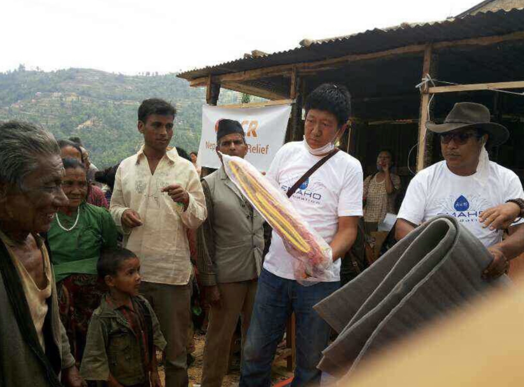 Emaho volunteers distributing supplies in a Nepal relief effort