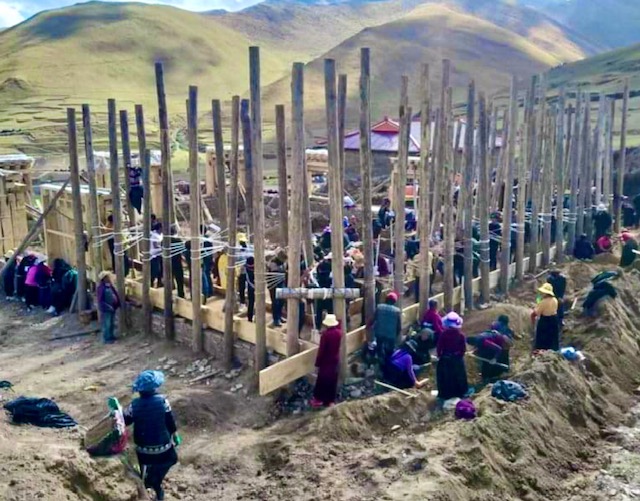 Community working together on monastery construction in the Tehor region